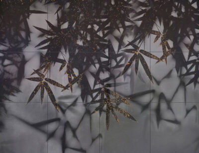 Dark palm leaves wall mural with a touch of gold on a tile