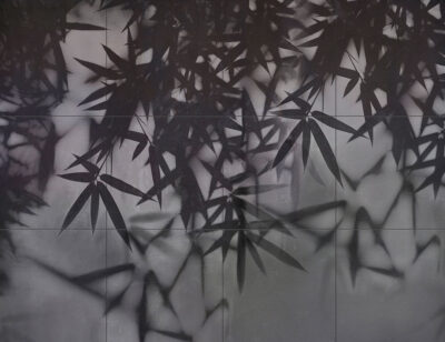 Dark palm leaves on a tile wall mural